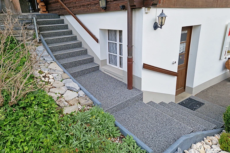 WARCO's anti-slip stair cladding in Light Granite runs directly in front of the house in the Alps.