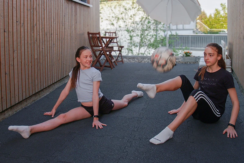 Children playing outside on elastic WARCO rubber flooring for play, leisure, fitness and indoor or outdoor use
