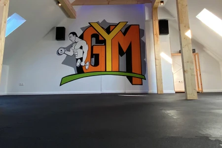 A smooth looking solid gym floor has been layed in this gym. A lot of space for cardio and group activities has been created with a nice anti slip surface for added saftey, and contact noise reduction
